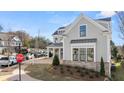 Two-story house with gray siding, brick accents, and a three-car garage at 1005 Coleman Place Dr, Roswell, GA 30075