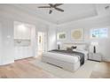 Bright main bedroom with tray ceiling, built-in cabinets, and hardwood floors at 1010 Coleman Place Dr, Roswell, GA 30075