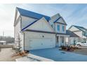 Two-story white brick home with gray roof, two car garage, and landscaping at 2870 S Waterworks Rd, Buford, GA 30518