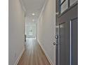 Hallway with wood-look floors, leading to a bright, airy living space at 695 Sunstone Ln, Lawrenceville, GA 30043