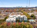 Stunning aerial view of the condo building with a pool and a city skyline backdrop at 130 Arizona Ne Ave # 104, Atlanta, GA 30307