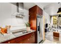 Close-up of the modern kitchen with stainless steel appliances and cherry wood cabinets at 130 Arizona Ne Ave # 104, Atlanta, GA 30307