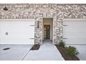 Townhome entrance showing brick facade, garage door, and front door with an open view to the interior at 691 Sunstone Ln, Lawrenceville, GA 30043