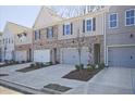New construction townhome showcasing a brick and siding exterior with attached two-car garage at 689 Sunstone Ln, Lawrenceville, GA 30043
