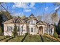 Charming home featuring a turret and welcoming front entrance with well-manicured landscaping at 6730 Polo Dr, Cumming, GA 30040