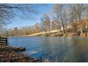 Serene pond with fall foliage, tranquil setting at 6740 Mountain Lake Ln, Cumming, GA 30028