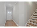 Welcoming foyer with wood-look flooring and staircase at 687 Sunstone Ln, Lawrenceville, GA 30043