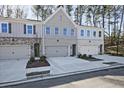 Charming townhome with a mix of brick and siding, featuring a two-car garage and landscaped front yard at 687 Sunstone Ln, Lawrenceville, GA 30043