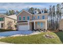 Two-story brick home with a three-car garage and a landscaped yard at 117 Belvedere Rd, Mcdonough, GA 30253