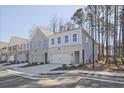 Attractive townhomes with attached garages, showcasing a contemporary design and curb appeal at 685 Sunstone Ln, Lawrenceville, GA 30043