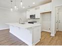 Modern kitchen with white cabinets, large island, and stainless steel appliances at 709 Trevett Way, Marietta, GA 30062