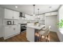 Modern kitchen with white cabinets, island, and stainless steel appliances at 599 Quillian Ave, Decatur, GA 30032