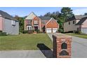 Brick house with a three-car garage and a brick mailbox at 1721 Telfair Chase Way, Lawrenceville, GA 30043