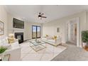 Bright living room with a fireplace, a ceiling fan, and access to a balcony at 351 Washington Ne Ave # 302, Marietta, GA 30060