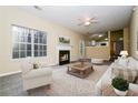 Bright living room with fireplace, plush seating, and open access to kitchen at 254 Cobblestone Ln, Mcdonough, GA 30252