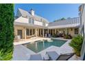 Inviting rectangular pool, surrounded by a patio and lush greenery at 6715 Berkley Rd, Cumming, GA 30040