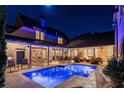 Stunning pool at night with blue lighting and beautiful landscaping at 6715 Berkley Rd, Cumming, GA 30040