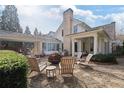 Backyard patio with a cozy fire pit and ample seating, perfect for outdoor entertaining at 6830 Vickery Creek Rd, Cumming, GA 30040