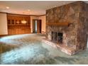 Bright living room features a stone fireplace and built-in wooden storage at 1200 Lakewood Ne Dr, Conyers, GA 30013