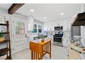 Well-lit kitchen with modern appliances, white cabinets, subway tile backsplash, and a movable island at 4760 Hillside Dr, Acworth, GA 30101