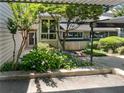 Charming home exterior with lush landscaping and covered parking area, enhancing curb appeal at 2007 Variations Ne Dr, Atlanta, GA 30329