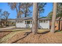 Front view of a white brick single-story home, showcasing its neat landscaping and curb appeal at 1723 Capistrana Pl, Decatur, GA 30032