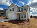 Charming two-story home featuring a covered porch, a two-car garage, and a nicely landscaped yard at 2116 Boxwood Se Cir, Conyers, GA 30094