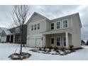 Two-story house with a beige exterior, white trim, and a two-car garage at 2116 Boxwood Se Cir, Conyers, GA 30094