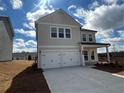 Charming two-story home with a two-car garage and a well-manicured lawn under a bright blue sky at 2116 Boxwood Se Cir, Conyers, GA 30094