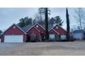 Red brick house with a two-car garage and manicured lawn at 2562 Pendergrass Ct, Ellenwood, GA 30294