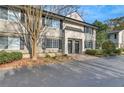 Inviting two-story townhome with neutral siding, black shutters, and well-maintained landscaping at 6940 Roswell Rd # E12, Atlanta, GA 30328