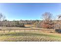 Expansive backyard featuring a well-maintained lawn and mature trees, perfect for outdoor activities and enjoying nature at 3975 Mcconnell Rd, Cumming, GA 30028