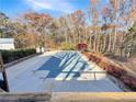 Backyard pool with a safety cover surrounded by greenery providing a private retreat at 7440 Banks Mill Rd, Douglasville, GA 30135