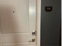 White front door with updated hardware, leading to unit 1419 at 870 Mayson Turner Nw Rd # 1419, Atlanta, GA 30314