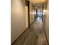 Long hallway with light-grey walls and wood-look flooring at 870 Mayson Turner Nw Rd # 1419, Atlanta, GA 30314