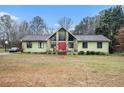 Inviting single-Gathering home featuring a red front door and beautiful stonework accents at 275 Helen Ln, Stockbridge, GA 30281