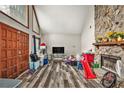 Cozy living room with a stone fireplace and stylish wood-look floors at 275 Helen Ln, Stockbridge, GA 30281