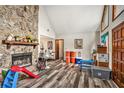 Cozy living room with a stone fireplace and stylish wood-look floors at 275 Helen Ln, Stockbridge, GA 30281
