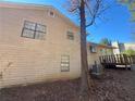 Side view of house showcasing wooden deck and tree at 2656 Del Ridge Dr, Douglasville, GA 30135