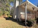 Side view of house with wooden porch and landscaping at 2656 Del Ridge Dr, Douglasville, GA 30135