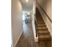 Foyer with wood-look flooring leading to an open concept kitchen and staircase to the second floor at 241 Ivey Ter # 42, Temple, GA 30179