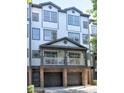 Beautiful townhome showcases a private covered front balcony and attached garages at 221 Semel Nw Cir # 273, Atlanta, GA 30309