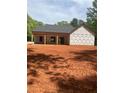 Exterior view of new construction home with covered porch and dark roof ready for siding install at 542 Palm St, Holly Springs, GA 30115
