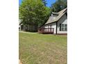 View of the side and back of home with wood deck and green lawn at 333 Pickfair Sw Way, Atlanta, GA 30315