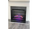 Modern electric fireplace with a black surround at 7621 Avalon Blvd, Fairburn, GA 30213