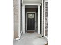 Dark gray front door with a white frame and sidelights at 7621 Avalon Blvd, Fairburn, GA 30213