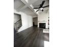 Spacious living room featuring a fireplace and dark hardwood floors at 7621 Avalon Blvd, Fairburn, GA 30213