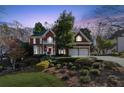 Brick home with landscaping, two-car garage, and charming curb appeal at 3880 Glenhurst Se Dr, Smyrna, GA 30080