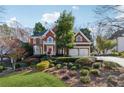 Two-story brick home with a two-car garage and lush landscaping at 3880 Glenhurst Se Dr, Smyrna, GA 30080
