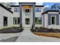 Beautifully landscaped front yard with a newly painted two-story home and custom trimmed windows at 4090 Sandy Lake Dr, Stonecrest, GA 30038